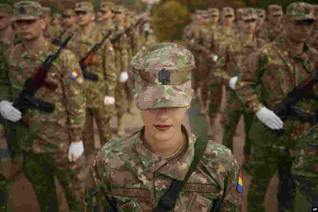 Military students stand in formation at the Unknown Soldier monument before a swearing-in ceremony on the Romanian Army Day in Bucharest, Romania.