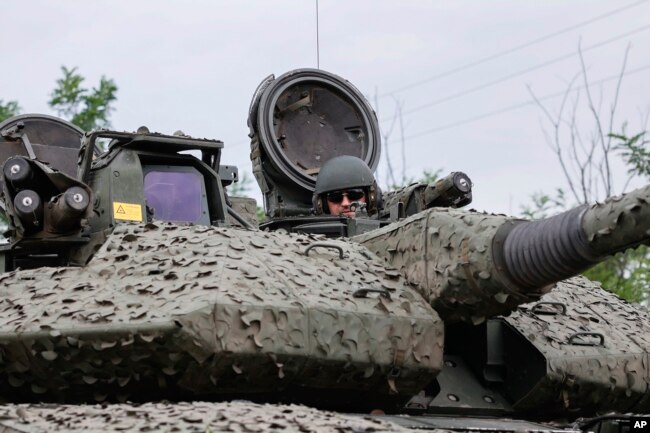 A Ukrainian soldier on a Swedish CV90 infantry fighting vehicle at his positions near Bakhmut, Donetsk region, Ukraine, June 25, 2023. (Roman Chop via AP)