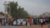 People gather on the street in east Khartoum on Apr. 16, 2023, as fighting in Sudan raged for a second day in battles between rival generals. 