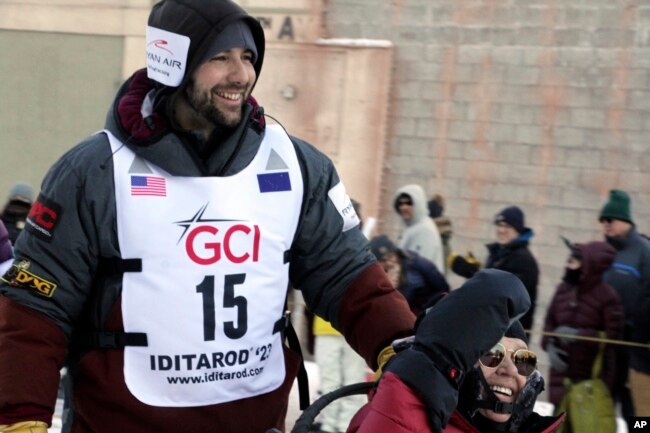 Musher Richie Diehl, wearing big No. 15, mushes down Fourth Avenue during the ceremonial start of the Iditarod Trail Sled Dog Race Saturday, March 4, 2023, in Anchorage, Alaska. (AP Photo/Mark Thiessen)