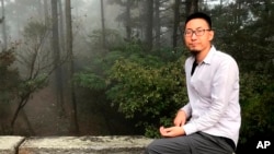 In this photo released by Free Huang Xueqin & Wang Jianbing, Chinese labor activist Wang Jianbing poses on Mount Lushan in Jiangxi province in April 2021.