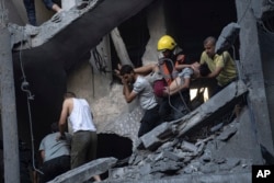 Warga Palestina mengevakuasi korban luka dari sebuah bangunan yang hancur akibat pemboman Israel di Khan Younis, Jalur Gaza, Kamis, 19 Oktober 2023. (Foto: AP)