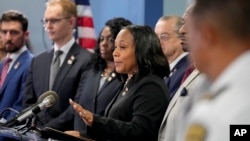 FILE — Fulton County District Attorney Fani Willis, center, speaks in the Fulton County Government Center during a news conference in Atlanta, Georgia, Aug. 14, 2023.