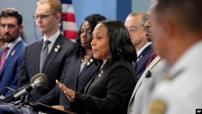 FILE - Fulton County District Attorney Fani Willis, center, speaks in the Fulton County Government Center during a news conference in Atlanta, Georgia, Aug. 14, 2023.