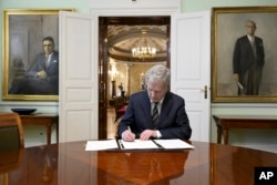 Finland's President Sauli Niinisto signs Finland's national NATO legislation in Helsinki, Finland, March 23, 2023.