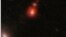 This image released by NASA shows the ZS7 galaxy system, revealing the ionized hydrogen emission in orange and the doubly ionized oxygen emission in dark red.  
