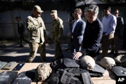 U.S. Secretary of State Antony Blinken looks a spent body armor while touring a State Border Guard of Ukraine Detached Commandant Office of Security and Resource Supply site in the Kyiv Oblast, Ukraine, Sept. 7, 2023.