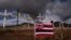A Hawaiian flag and crosses honoring the victims killed in a recent wildfire are posted along the Lahaina Bypass in Lahaina, Hawaii, Aug. 21, 2023. 