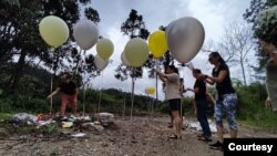 On the one-year anniversary of the landslide, victims families and survivors gathered at the site to light candles, say prayers and release balloons with messages to those who perished. (Courtesy Tan Ei Ein)