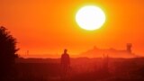 A migrant walks back to his makeshift camp at sunrise after a failed attempt to cross the Channel to the UK on a small boat, in Sangatte, near Calais, France, Aug. 10, 2023. 