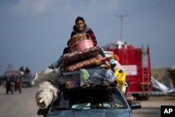 Palestinians arrive in the southern Gaza town of Rafah after fleeing an Israeli ground and air offensive in the nearby city of Khan Younis, Jan. 24, 2024.