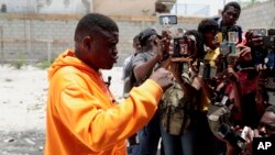 Jimmy Cherizier, the leader of the G9 et Famille gang, speaks to journalists in Delmas 6, a district of Port-au-Prince, Haiti, Aug. 16, 2023. 