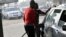 FILE - A fuel attendant fills a tank at a fuel station in Kano, northwest Nigeria, on Feb. 8, 2023.