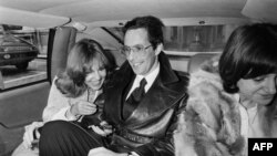 FILE - Film director William Friedkin, and his wife, French actress Jeanne Moreau, share a laugh during their wedding in Paris, on Feb. 8, 1977.