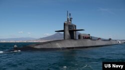 FILE - The guided missile submarine USS Florida conducts a brief stop in the Bay of Naples, Naples, Italy, March 16, 2023. 