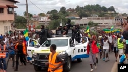 This video grab shows coup supporters cheering police officers in Libreville, Gabon, Aug. 30, 2023. 