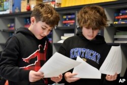 Miles Tunstill, left, and Grayson Pollard go over their lines of a three-scene play written by ChatGPT in Donnie Piercey's class at Stonewall Elementary in Lexington, Ky., Monday, Feb. 6, 2023.