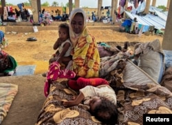 FILE - Families displaced by RSF advances in Sudan's El Gezira and Sennar states shelter at the Omar ibn al-Khattab displacement site, Kassala state, Sudan, July 10, 2024.