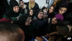 Family of Palestinian militant Samer El Shafei mourn over his body in the Nur Shams refugee camp near the city of Tulkarem, in the occupied West Bank, May 6, 2023.