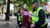 FILE - An anti-immigration protester is detained by police officers, in Newcastle, Britain Aug. 10, 2024. 