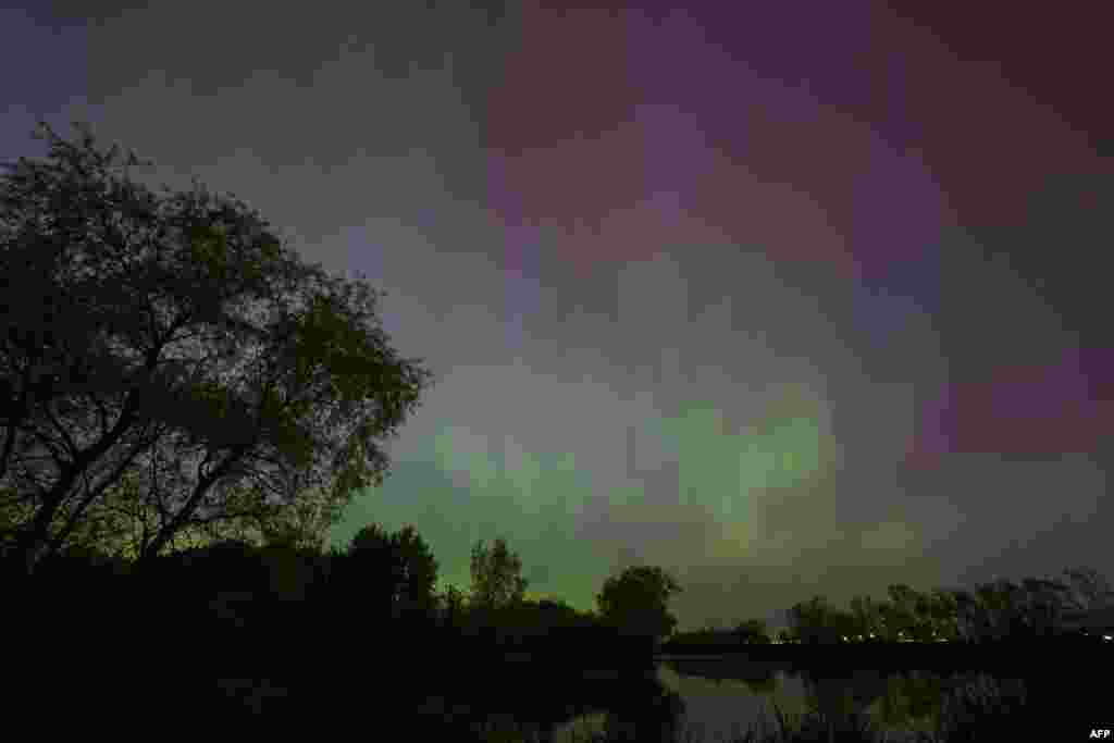 Northern lights illuminate the night sky near London, Ontario, during a geomagnetic storm, May 10, 2024.