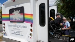 Resident Billy Church is helped into a van headed for a group lunch at Stonewall Gardens, an LGBTQ assisted living facility, on Aug. 15, 2023, in Palm Springs, California. About 171,000 of the more than 1.3 million transgender adults in the United States are 65 and older.