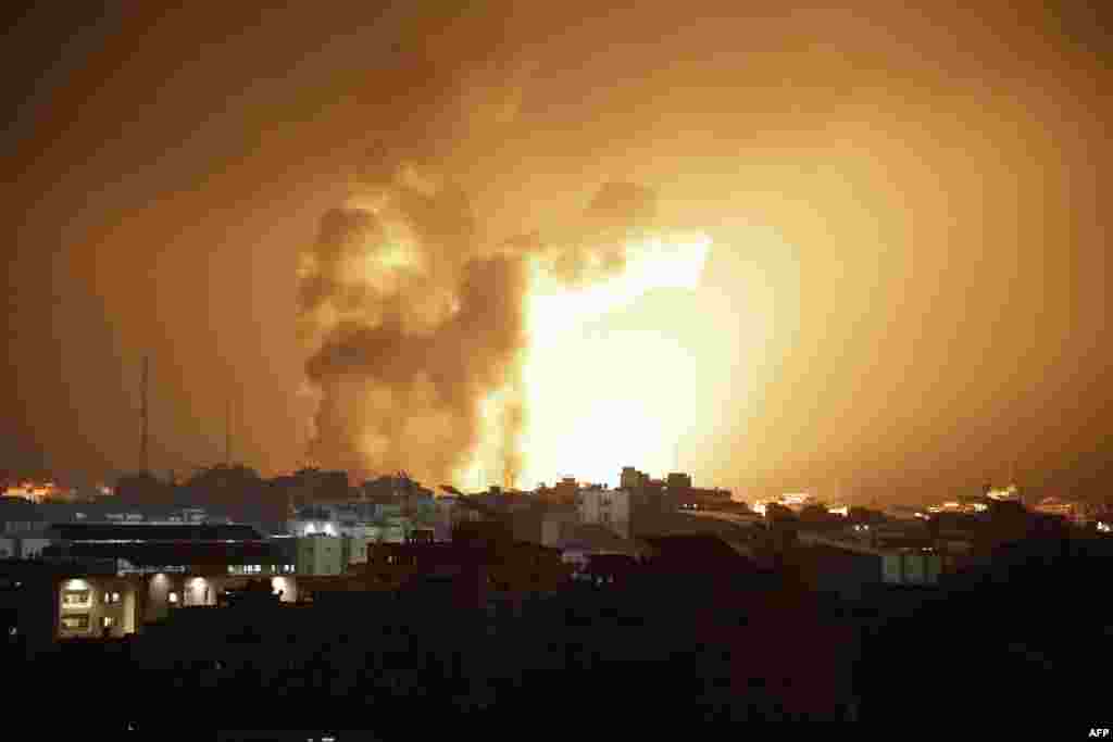 Fire and smoke rises above buildings during an Israeli airstrike in Gaza City on Oct. 8, 2023.