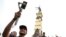 Douglas Guzman takes video with his smartphone at Liberty Plaza in San Salvador,  June 24, 2023. Guzmán is part of a network of social media personalities acting as a megaphone for, and cashing in on, El Salvador President Nayib Bukele's message. 