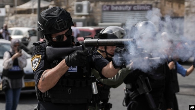 Israeli security forces shoot tear gas canisters towards Palestinians during riots near Jerusalem's Old City, Oct. 27, 2023.