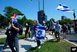 Counterprotesters arrive at Union Park before a march to the Democratic National Convention, Aug. 19, 2024, in Chicago.