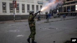 A police officer fires tear gas during a protest in Nairobi, Kenya, July 16, 2024.