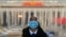 A soldier dressed as an usher stands guard at an entrance door of the Great Hall of the People in Beijing, March 3, 2023.