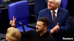 Ukrainian President Volodymyr Zelenskyy, middle, gestures following his address to the lower house of parliament Bundestag in Berlin, Germany, June 11, 2024.