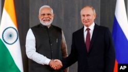 FILE - Russian President Vladimir Putin, right, and Indian Prime Minister Narendra Modi pose for a photo on the sidelines of the Shanghai Cooperation Organization (SCO) summit in Samarkand, Uzbekistan, Sept. 16, 2022. 