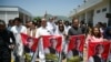FILE - Parliamentarians of the Pakistan Tehreek-e-Insaf (PTI) party carry posters of jailed former prime minister Imran Khan, during a protest outside the Parliament house in Islamabad on July 18, 2024. 