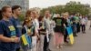 People attend a flash mob to highlight the plight of hundreds of Ukrainian athletes and coaches, both amateur and professional, who were killed as a result of Russia's war in Ukraine in Paris, France, July 31, 2024, during the 2024 Summer Olympics. 