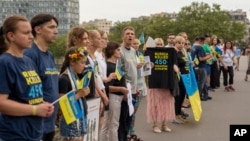 People attend a flash mob to highlight the plight of hundreds of Ukrainian athletes and coaches, both amateur and professional, who were killed as a result of Russia's war in Ukraine in Paris, France, July 31, 2024, during the 2024 Summer Olympics. 