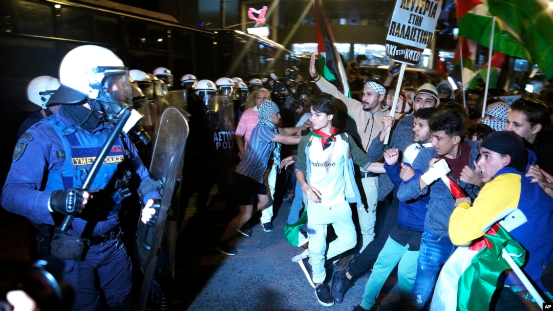 Protesters scuffle with riot police during a rally outside the Israeli Embassy in Athens, Greece, Oct. 18, 2023.