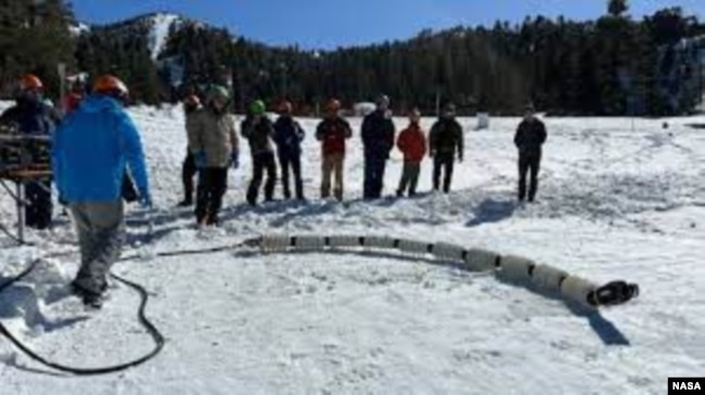 Team members from JPL test a snake robot called EELS at a ski resort in the Southern California mountains in February 2023. (Photo Credit: NASA/JPL-Caltech)