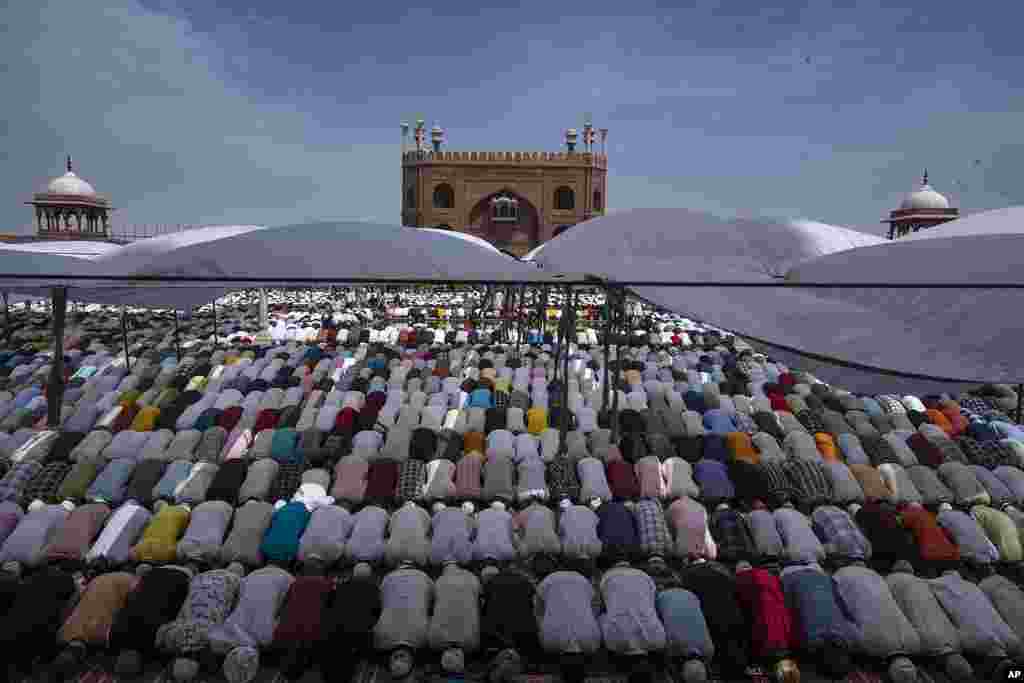 Indian Muslims pray together on the last Friday of the holy fasting month of Ramadan at Jama Masjid in New Delhi, India.