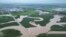 In this photo released by Xinhua News Agency, floodwaters course through fields and roads in Kaiyuan Town of Shulan in northeastern China's Jilin province,  Aug. 4, 2023.