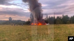 This image released and watermarked by Ostorozhno Novosti on Aug. 23, 2023, shows the crash site of a private jet near Kuzhenkino, Russia. Russia's civil aviation agency says mercenary leader Yevgeny Prigozhin was aboard the plane and was one of 10 people killed.