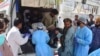 Paramedics and volunteers carry an injured victim of a bomb explosion upon arrival at a hospital, in Quetta, Pakistan, Sept. 29, 2023.