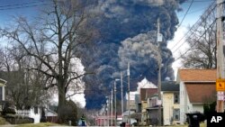 FILE - A plume rises over East Palestine, Ohio, as a result of the controlled detonation of a portion of the derailed Norfolk Southern trains, Feb. 6, 2023. 