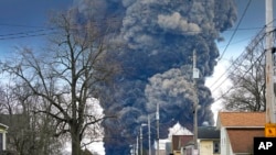FILE - A plume rises over East Palestine, Ohio, as a result of the controlled detonation of a portion of the derailed Norfolk Southern trains, Feb. 6, 2023. 