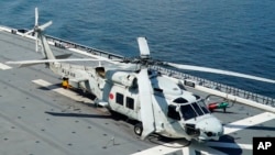 FILE - An SH-60K helicopter sits on the flight deck of Japan's Maritime Self Defense Force helicopter carrier JS Izumo (DDH-183) off the coast of Brunei, June 26, 2019. Late April 20, 2024, contact was lost with two Japanese navy SH-60K choppers.