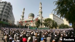FILE - Muslims attend a prayer session at Dongguan Mosque during Eid al-Fitr in Xining, Qinghai province, Sept. 9, 2010. It was among the most famous places of worship to undergo Sinicization, its distinctive domes and minarets toppled in 2021.