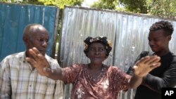 A woman expresses her happiness following the release of American nurse Alix Dorsainvil and her young daughter, outside the El Roi Haiti school academy in Cite Soleil community of Port-au-Prince, Haiti, Aug. 9, 2023. 