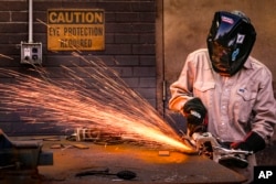 Student Abbey Carlson works during welding class at Tennessee College of Applied Technology Nashville Wednesday, April 13, 2023, in Nashville, Tenn. (AP Photo/John Amis)