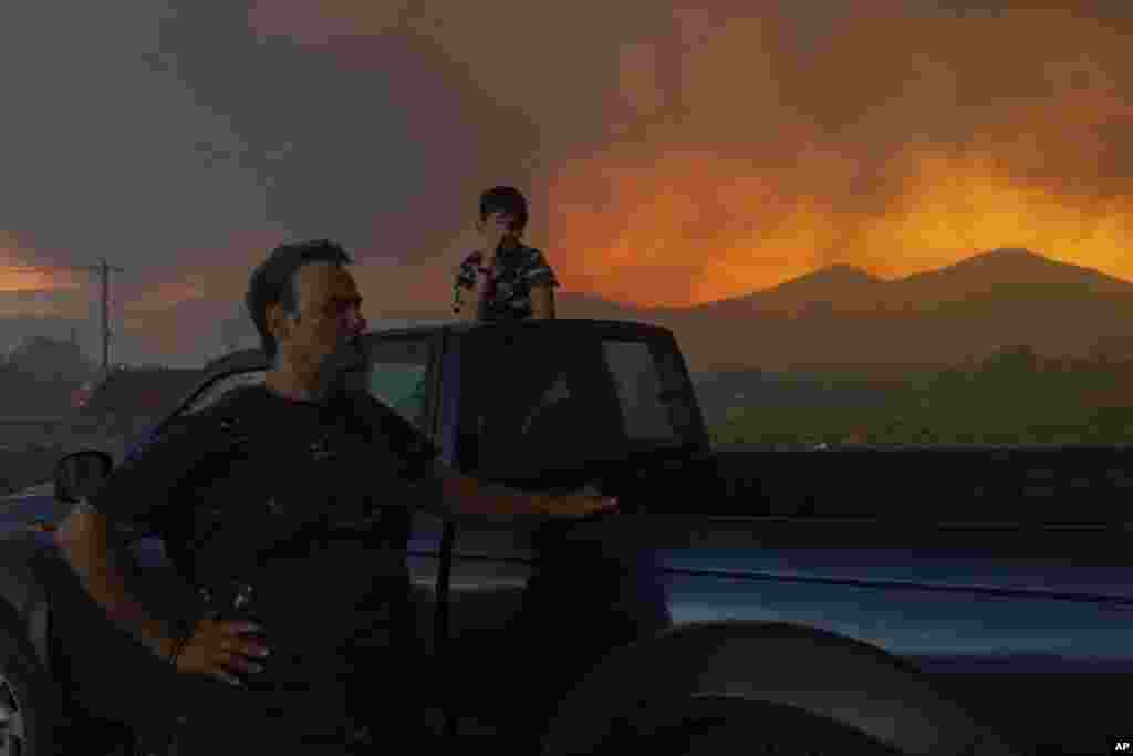 Local residents watch a wildfire in Avantas village, near Alexandroupolis, Greece, Aug. 21, 2023. 